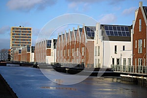 Modern waterfront houses with solar panels on the roof in the city of the sun Heerhugowaard