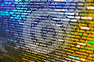 Modern web development background. Software background technology. Software developer programming code on computer monitor.