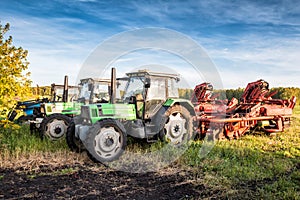 Modern wheeled agricultural tractors with harvesting equipment