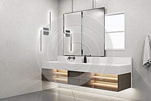 Modern white bathroom interior with washbasin and mirrors.