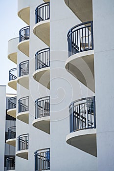 Modern white building exterior with semi rounded balconies in Destin Florida