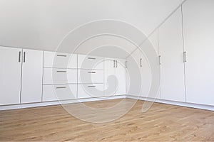 Modern white built-in wardrobe with laminate floor