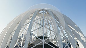 Modern white dome-shaped structure. Stock footage. Top view of beautiful domed structure in modern city. Beautiful domed