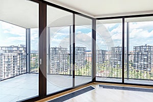 Modern white empty loft apartment interior with parquet floor and panoramic windows, Overlooking the metropolis city