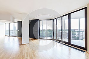 Modern white empty loft apartment interior with parquet floor and panoramic windows, Overlooking the metropolis city