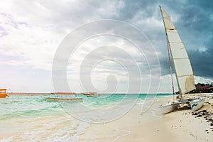 Modern white expensive catamaran vessel ashore