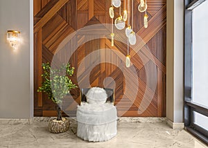 Modern white feather armless chair, plant pot, decorated wood cladding wall, and big glass window