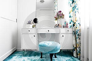 white, feminine dressing room with minimalist vanity table and mirror photo