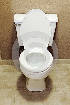 A modern, white, flushing, water conserving toilet.