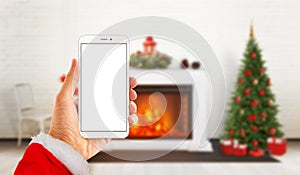 Modern white hone in Santa Claus hand with isolated screen for mockup.