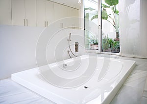 Modern white house bathroom bathtub with courtyard skylight