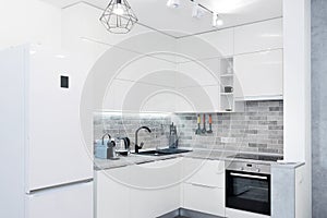 Modern white kitchen interior. Contemporary interior with loft elements.
