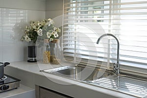 Modern white kitchen unit and cooking stove.