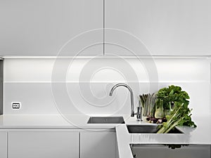 Modern white kitchen with vegetables