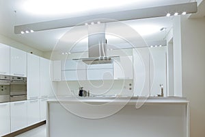 Modern white kitchen with wood floor photo