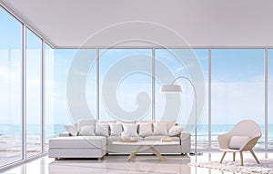 Modern white living room with sea view 3d rendering image.There are large window overlooks to sea view. photo