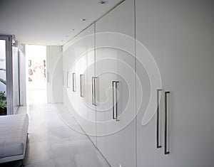 Modern white long corridor closet, contemporary