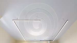 Modern white matte stretch ceiling with original fixtures