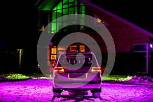 modern white off-roader at night under purple light