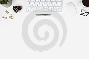 Modern white office desk table with computer gadgets, cup of coffee and office supplies. Top view with copy space, flat lay