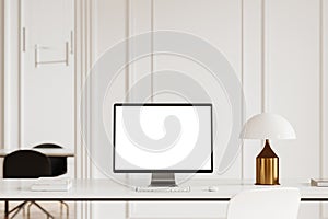 Modern white office interior with pc computer and mockup screen on table