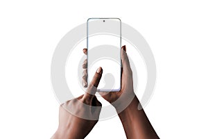 Modern white perla smart phone in woman hands. Low light, dark skin, isolated in white photo