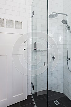 Modern white shower in bathroom renovation with brick pattern ti