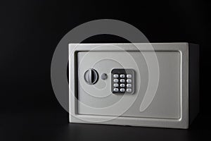 Modern white steel money bank safe on a dark background with a coded lock. photo