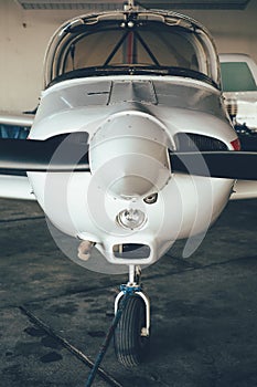 Modern white ultralight sport airplane in hangar