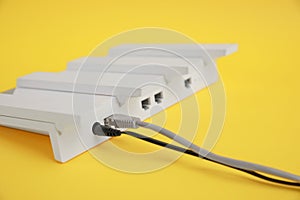 Modern Wi-Fi router on yellow background, closeup