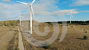 Modern wind towers generating power. Green energy, renewable energy concept.