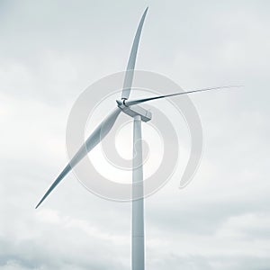 Modern Wind Turbine Against Cloudy Sky