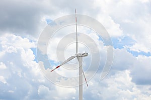 Modern wind turbine against cloudy sky. Alternative energy source
