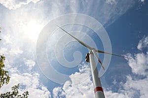 Modern wind turbine against sky, low angle view. Alternative energy source