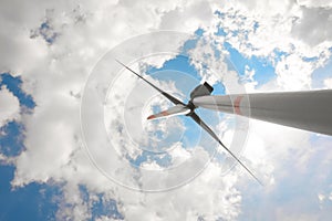 Modern wind turbine against sky, low angle view. Alternative energy source