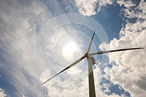 Modern wind turbine against sky, low angle view. Alternative energy source