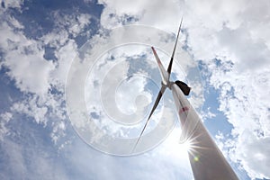 Modern wind turbine against sky, low angle view. Alternative energy source