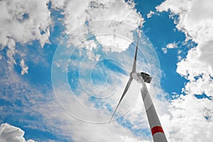 Modern wind turbine against sky, low angle view. Alternative energy source