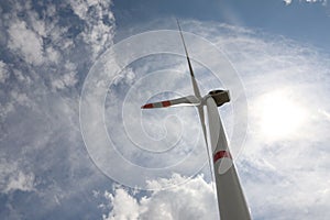 Modern wind turbine against sky, low angle view. Alternative energy source