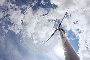 Modern wind turbine against sky, low angle view. Alternative energy source