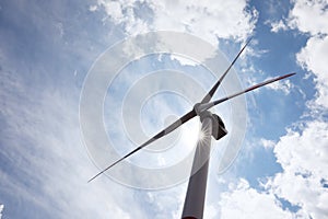 Modern wind turbine against sky, low angle view. Alternative energy source