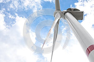 Modern wind turbine against sky, low angle view. Alternative energy source