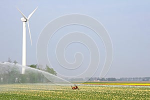 Modern wind turbine delivers renewable alternative energy to sprinkle the Noordoostpolder, Flevoland, Netherlands