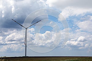 Modern wind turbine in field on day. Alternative energy source