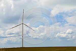 Modern wind turbine in field on day. Alternative energy source