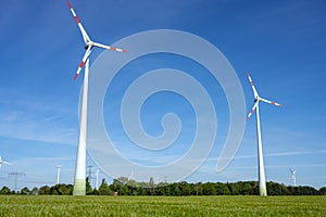 Modern wind turbines with a clear blue sky