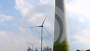 modern wind turbines in the forest with camera movement