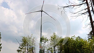 modern wind turbines in the forest with camera movement