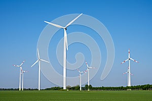 Modern wind turbines in front of a blue sky