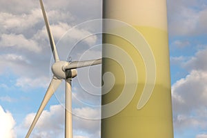 Modern wind turbines in front of a cloudy sky